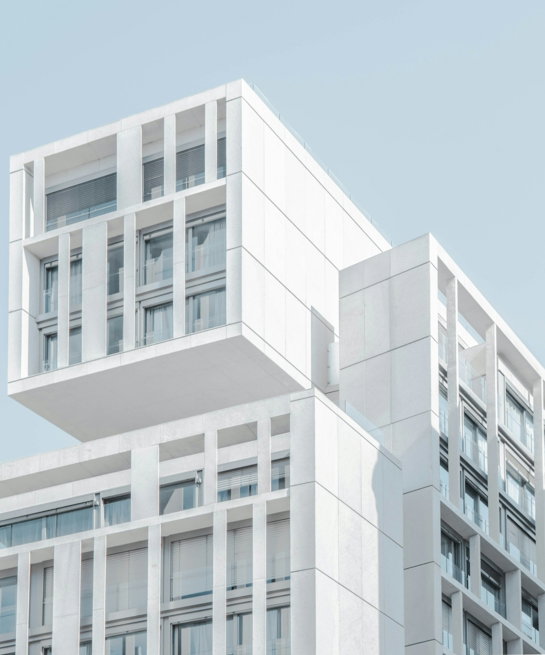 white modern cement building under blue sky